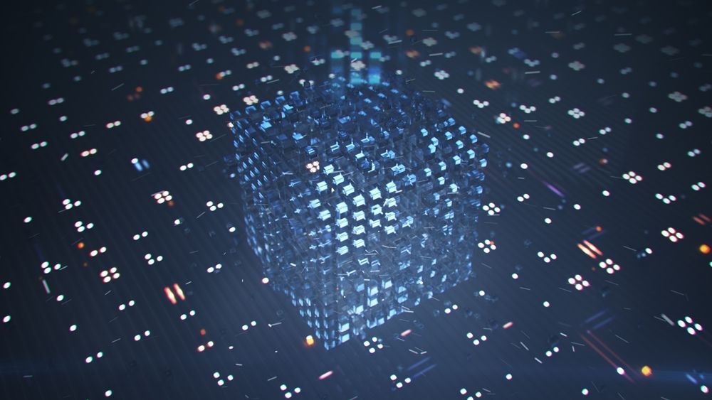 Glowing blue cube assembled from many small blocks, floating above a field of scattered data points.