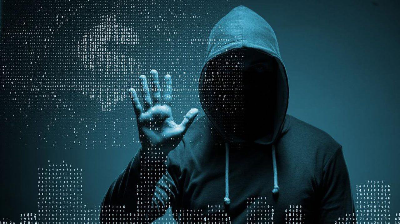 A hooded figure with an unseen face reaching into a wall of glowing digits that forms a city skyline.